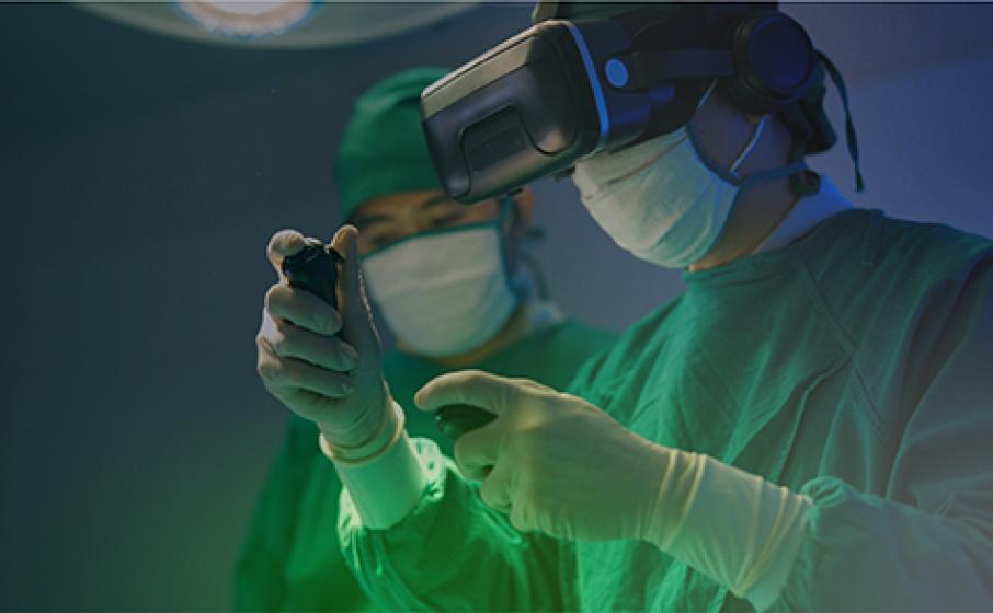 A medical technician in personal protection equipment using a virtual reality headset.