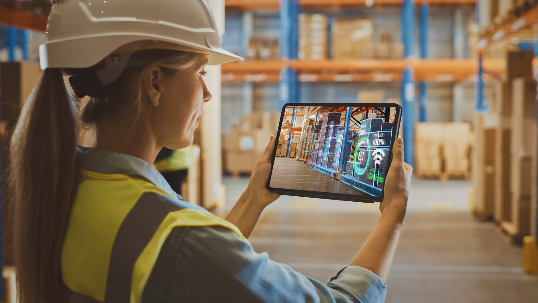 A woman using in a warehouse using an augmented reality tablet