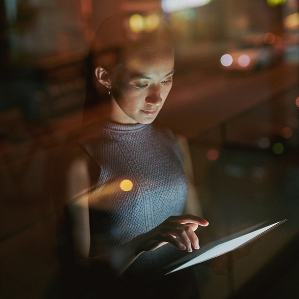 A woman using an electronic tablet in her office
